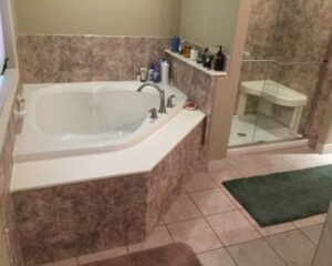 Bright modern bathroom with walk-in shower, glass enclosure, and updated vanity design