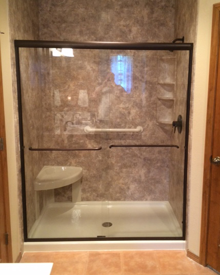 Framed Glass Walk-In Shower With Built-In Seat, Grab Bars, And Tiled Walls