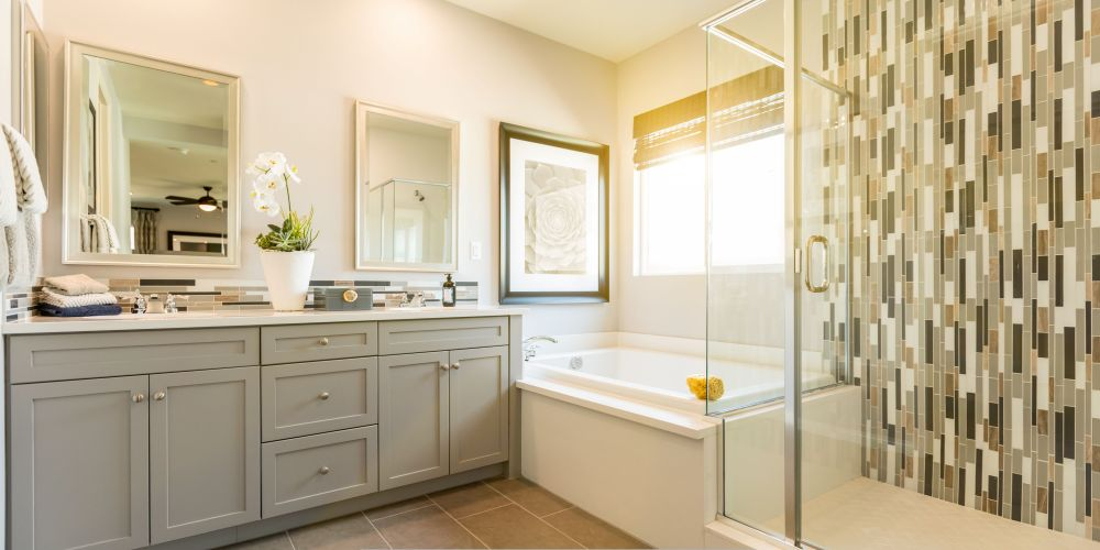 Bright remodeled bathroom with a glass shower and improved ventilation.